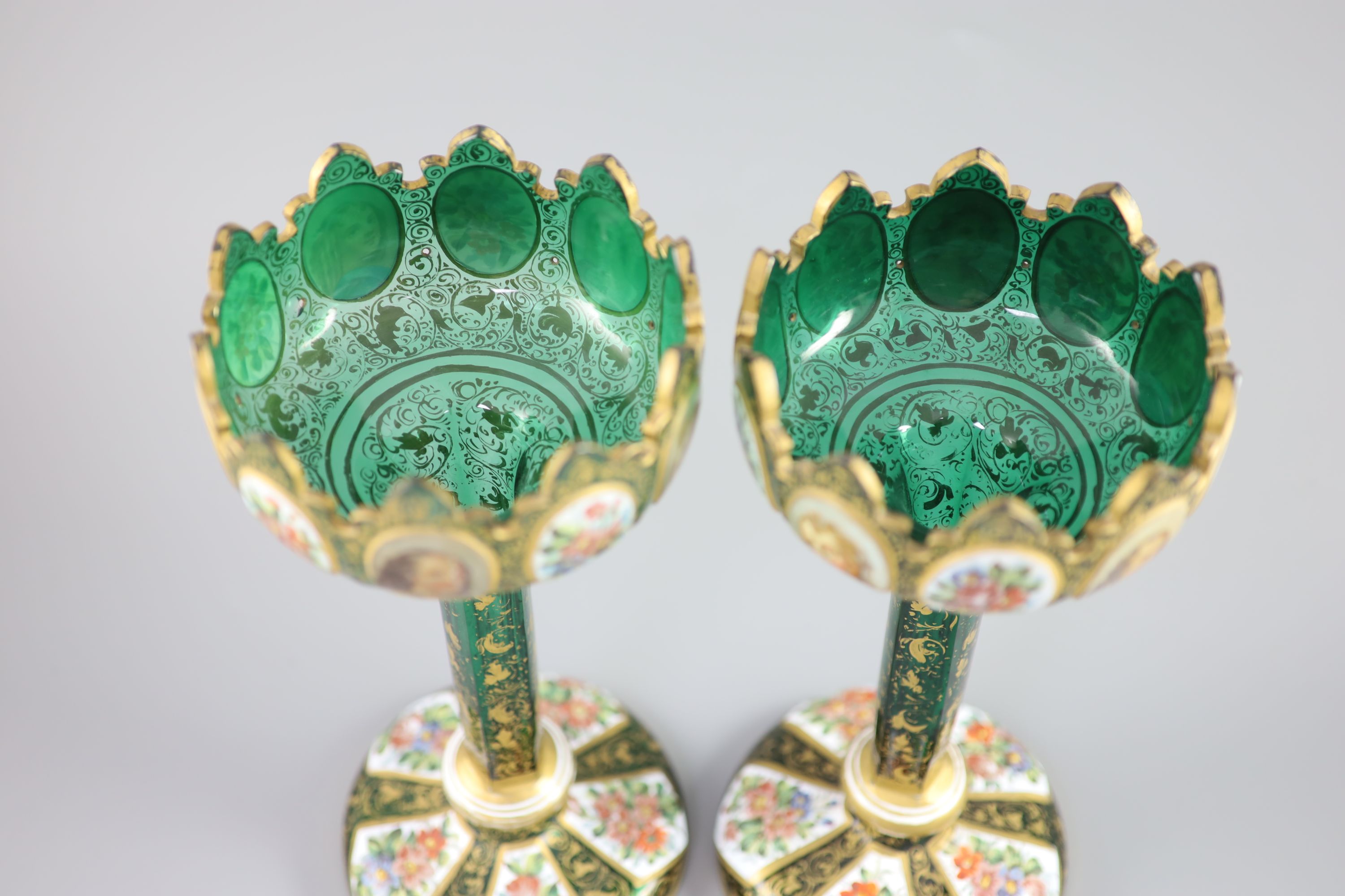 A pair of Bohemian enamelled white overlaid green glass vases, late 19th century, 31cm high